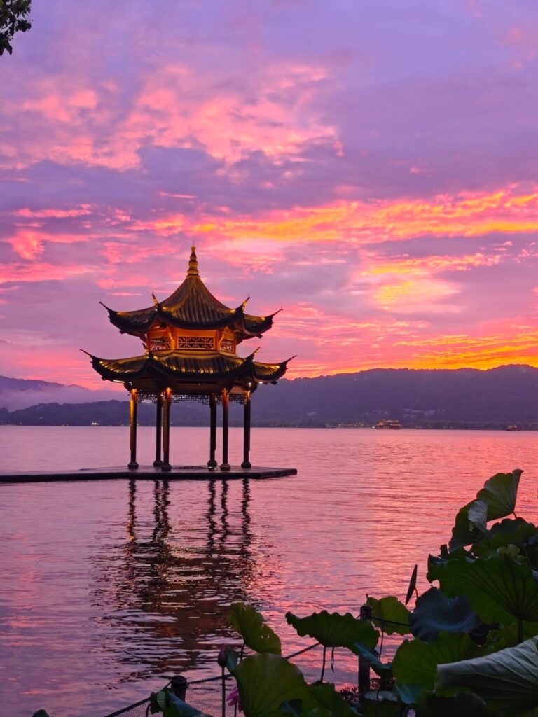 Leifeng Pagoda reflected in West Lake at sunset — Hangzhou's most iconic view